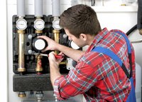 A technician services a heating system.