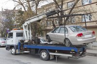 Tow truck removing car from the street