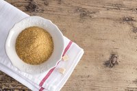 A small bowl of brown sugar on a countertop.