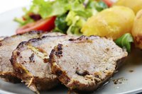 Slice cooked pork tenderloin after letting it rest for at least 3 minutes.