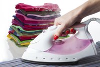 An iron with a dry setting is typically used to transfer appliques from paper to garment.