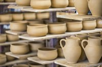 Shelves filled with pottery in a ceramics shop.