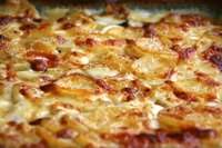 As the cream thickens, it forms the gratin's characteristic golden crust.