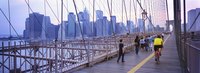 The Brooklyn Bridge's pedestrian promenade rises above vehicular traffic and has a dedicated bike lane.