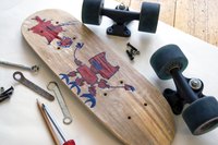 Disassembled skateboard with illustration on bottom