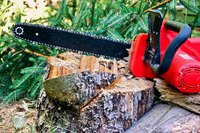 Close-up of chainsaw on tree stump