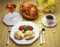Fixing a curdled Hollandaise sauce can be accomplished with egg yolk and warm water.