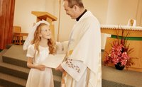 Girl receiving a certificate for taking her First Communion.