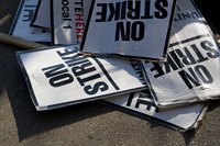A pile of "On Strike" signs.
