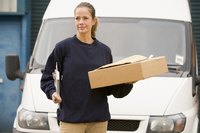 Courier with package in front of company van