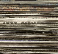 Decoupage newspaper pieces onto canvas to create a one-of-a-kind work of art.