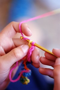 It's not difficult to crochet a bit of yarn into an adorable baby dress.