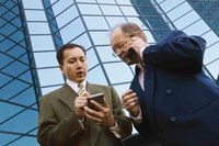 Two businessmen are on their phones.
