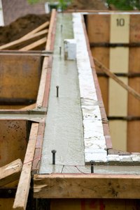 Some sill plates are attached to bolts embedded in wet concrete; others are drilled.