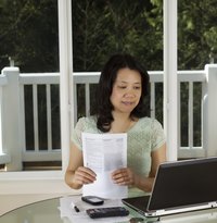 A tax preparer reviewing income tax forms