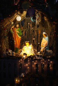 A cardboard stable can serve in a nativity scene.