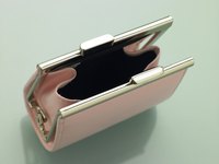 Coin purses often feature metal-hinged clasps, which give them strength and keep your change contained.