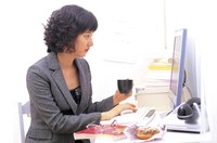 A business woman is working at her desk.