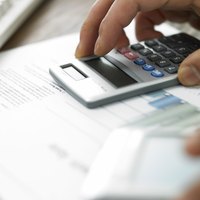 Close-up of man using calculator for business costs