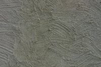 Stucco is not a great insulator, but insulates better than cement.