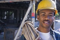A construction worker is smiling on the jobsite.