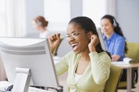 An excited businesswoman is cheering at her desk.