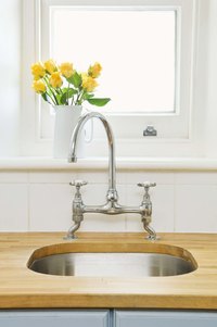 Stainless steel faucets reflect light and add brightness to a kitchen.