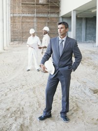 Civil engineer project managers visit construction sites to keep work on schedule.