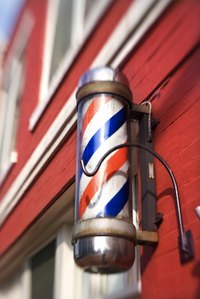 Paint the colored lines on a barber pole.