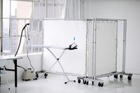 Room dividers create an organized-looking makeshift closet.