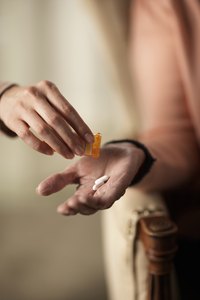 Close-up of Phillips' Colon Health Probiotic Capsules being poured into woman's hand.