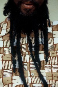 To dreadlock, run pinched fingers up and down the braid.