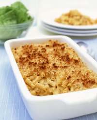 Making baked macaroni and cheese using chicken broth instead of milk can be done but will change the end result slightly.