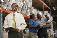 Employees looking at inventory in warehouse.