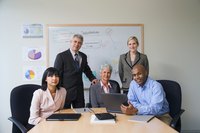 People are sitting in a conference room going over a business plan.