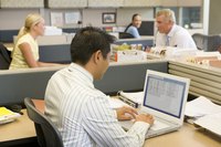 Four employees working in an office.