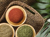 A basket of spices on a palm leaf.