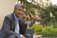 Smiling businessman on a cellphone.
