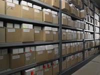 Merchandise is stacked on warehouse shelves.