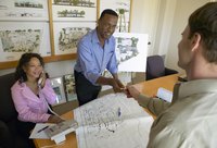 A landscape architect handing a client a card.
