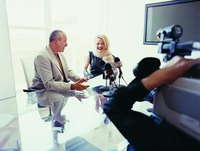 A news reporter is interviewing a man.