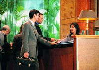 Man checking into a hotel at reception.