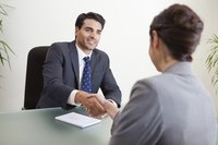 Man shaking job candidates hand.