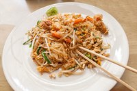 A plate of pad thai with iron-rich components including shrimp, bean sprouts and crushed peanuts.