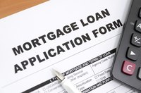 Mortgage loan form with pen and calculator.