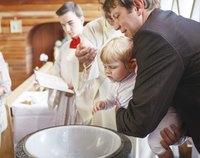 Baby boy being christened in church.