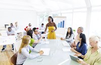 Woman giving seminar about team building in office place