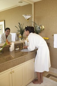 Bathroom vanities are shorter than kitchen sinks, forcing adults to stoop over.