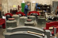 A machinist working on bells for a historic church.
