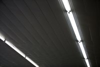 Fluorescent lighting in a garage may sometimes be slow to come on.
